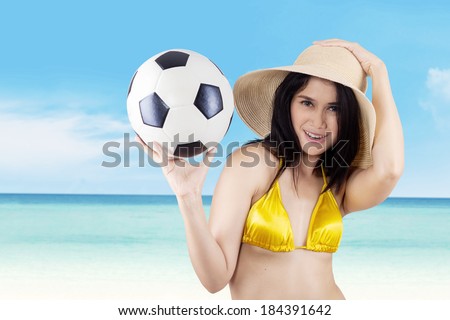 Attractive sexy woman soccer fans holding a soccer ball.