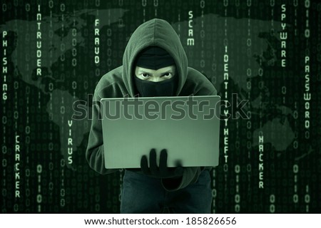 Hacker typing on a laptop with binary code background