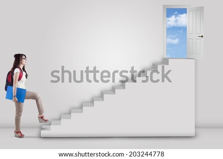 College student stepping up on stairs to the success door