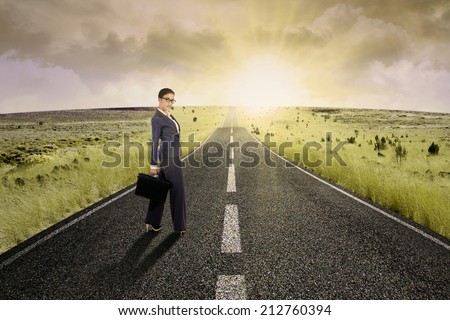 Businesswoman standing on the highway road, symbolizing as the way to the new opportunity