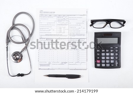 Unique Perspectives of Health insurance concept. Stethoscope, health form, pen, glasses, and calculator.