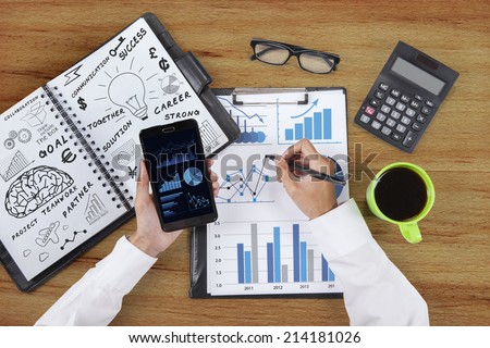 Unique Perspectives of businessman hands working with smart phone and business chart