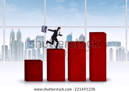 Asian business person runs hurry above business graph