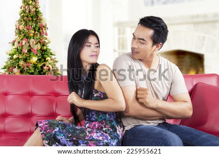 Portrait of asian people quarreling at home with christmas tree background