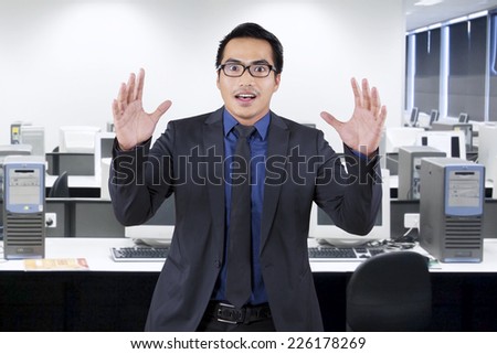 Portrait of asian entrepreneur with shocked expression face, shot in the office