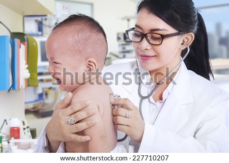 Portrait of baby girl crying in hospital when checkup with her doctor