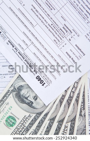 Tax return concept with dollar money on the tax form, shot in the studio