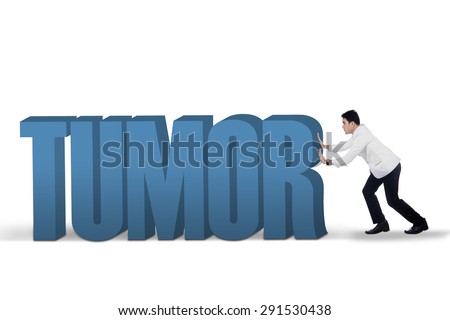 Portrait of young asian doctor pushing a text of Tumor, isolated on white