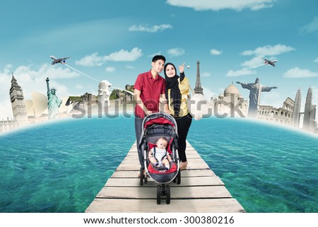 Two young parents carrying their baby to travel the world monuments