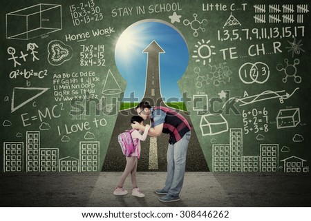 Young father kiss his daughter before going to school in front of a key hole with scribble and upward arrow