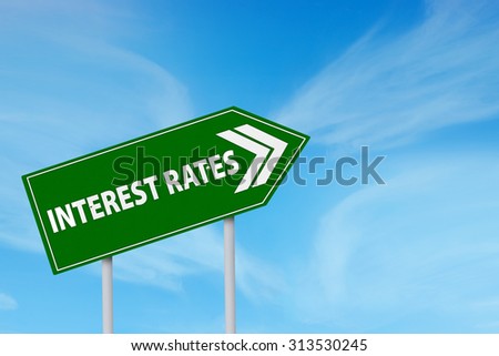 Roadsign of higher interest rates ahead against blue sky