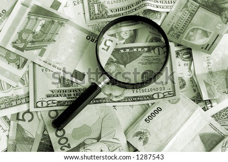 Magnifying glass with US Dollars, Australian Dollars, Euro and some Asian currency
