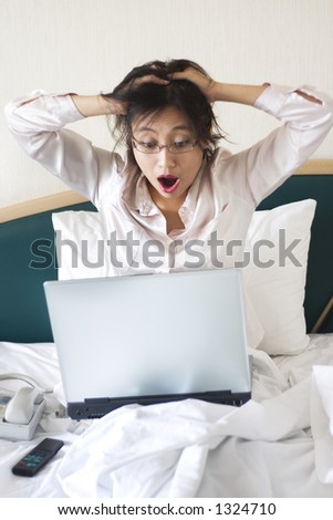 Shocked businesswoman in bed