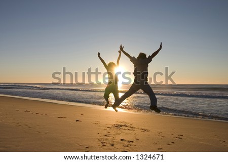 Happy people jumping around at sunrise