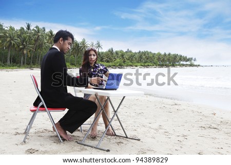 Casual business team meeting on the beach