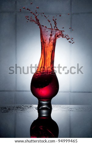 Splashing strawberry into a glass of drink