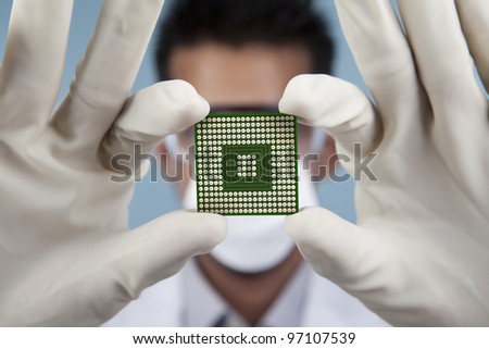 A scientist showing of a closeup computer chip