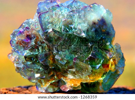 Fluorspar crystal mineral on coloured background