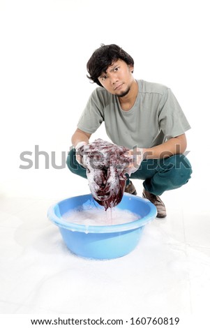 Thai man washing by hands in plastic bowl