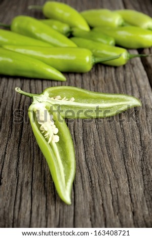 sliced green fresh banana pepper on wooden table