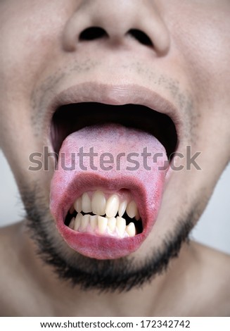 scary concept, crooked teeth on tongue