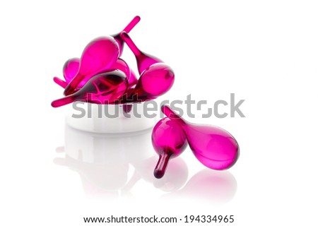 pink hair vitamin oil serum capsule isolated on white background