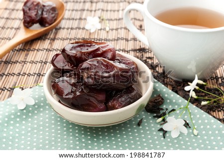 closeup sweet dried dates fruit with tea