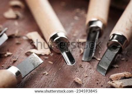 closeup chisels for wood on carpenter desktop