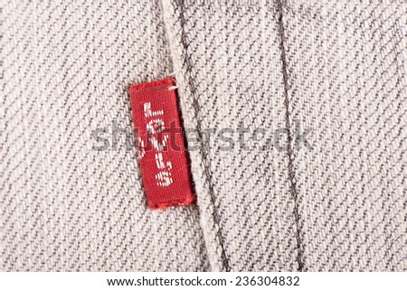 BANGKOK, THAILAND - DECEMBER 09 2014: Close up of the LEVI\'S red label on the back pocket of old denim jeans. LEVI\'S is a brand name of Levi Strauss and Co, founded in 1853.