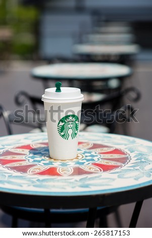 BANGKOK, THAILAND - APRIL 02, 2015: White paper cup with Starbucks logo. Starbucks is the world's largest coffee house with over 20,000 stores in 61 countries.
