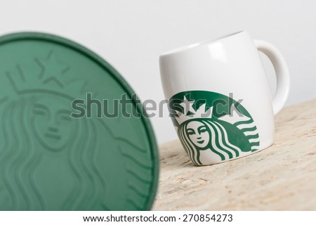 BANGKOK, THAILAND - APRIL 20, 2015: White cups with Starbucks logo. Starbucks is the world\'s largest coffee house with over 20,000 stores in 61 countries.