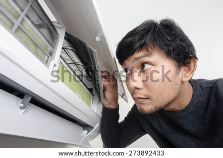 a man look inside the air condition