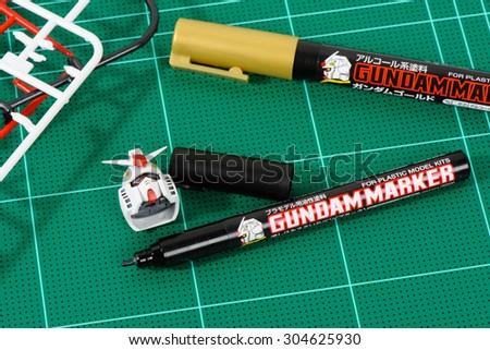 BANGKOK, THAILAND - AUGUST 06, 2015: The Gundam Marker (marker for plastic model kits) on cutting mat.