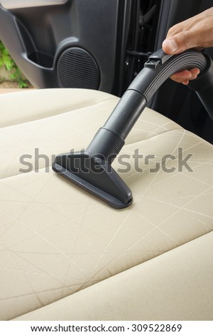 cleaning the car with vacuum cleaner