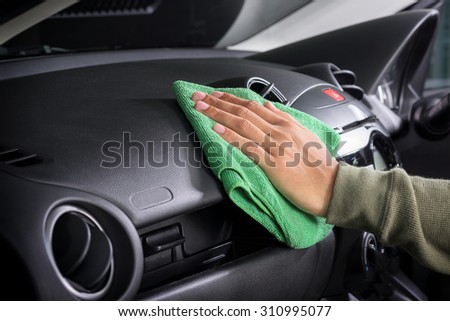 cleaning the car console with microfiber cloth