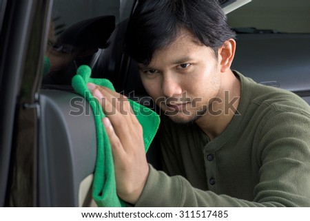 asia man cleaning the his car with microfiber cloth