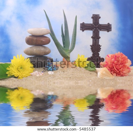 Cross and Flowers on Sand With Aloe Vera Plant