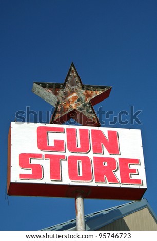Vintage Gun Store Sign with Blue Sky