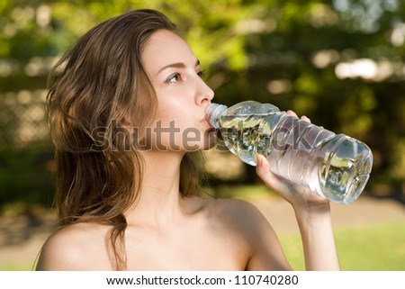 Portrait of a gorgeous young brunette woman enjoying cool clean water.
