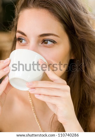 Portrait of a brunette beauty enjoying her coffee.