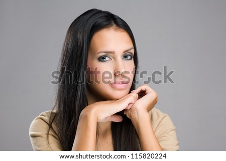 Portrait of a beautiful brunette woman with pondering expression.