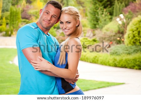 Outdoors portrait of a very fit attractive young couple.