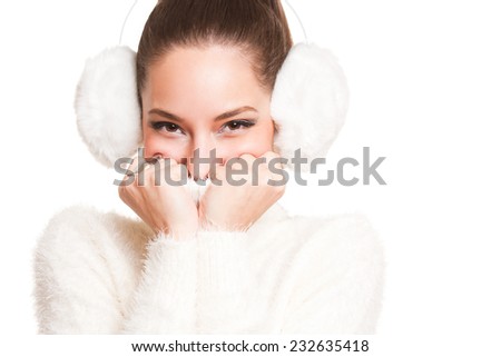 Gorgeous young brunette woman dressed in all white warm clothes.
