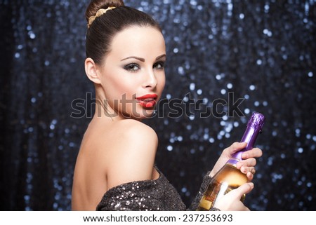 Portrait of an elegant festive brunette in sequin dress.