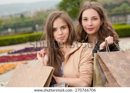 Couple of brunette beauties having shopping fun.
