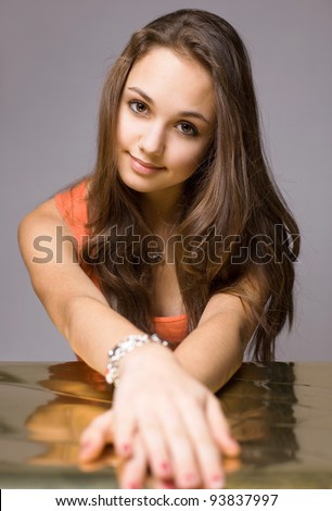 Sweet flirty young brunette reaching out towards the camera.