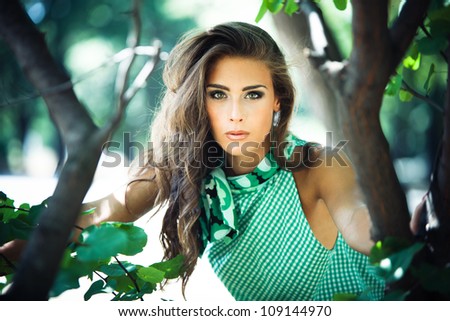 young woman in green dress fashion  shot in the wood summer day