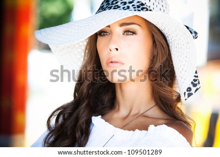 young elegant woman outdoor portrait with hat summer day