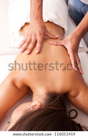 woman enjoy in back massage in spa salon