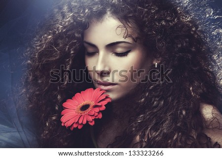 curly hair  young woman beauty portrait with flower